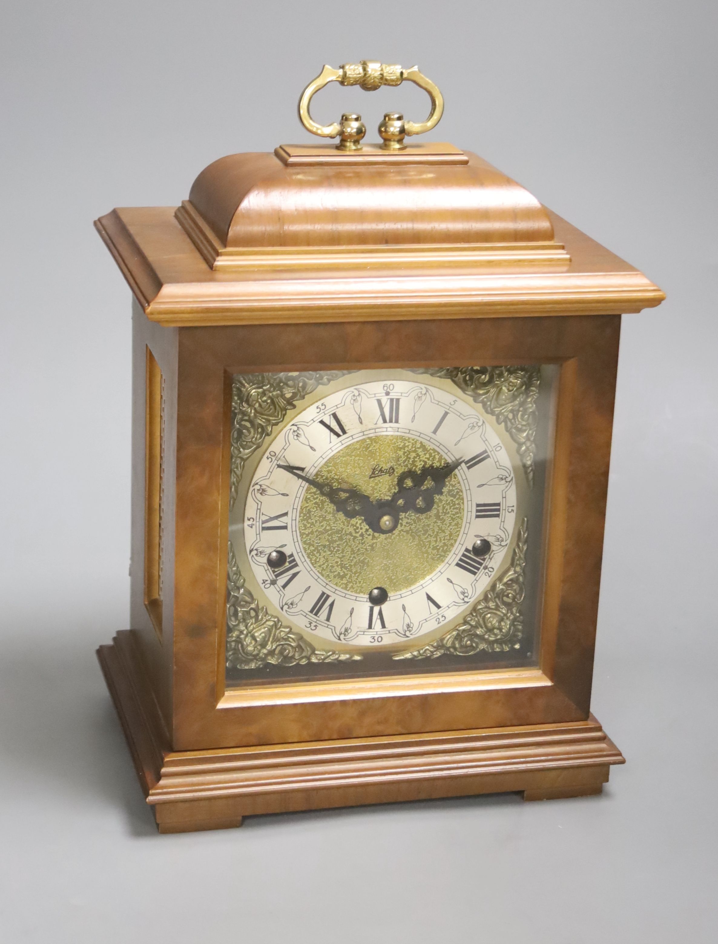 A modern walnut mantel clock, with German striking and chiming movement, height 29cm